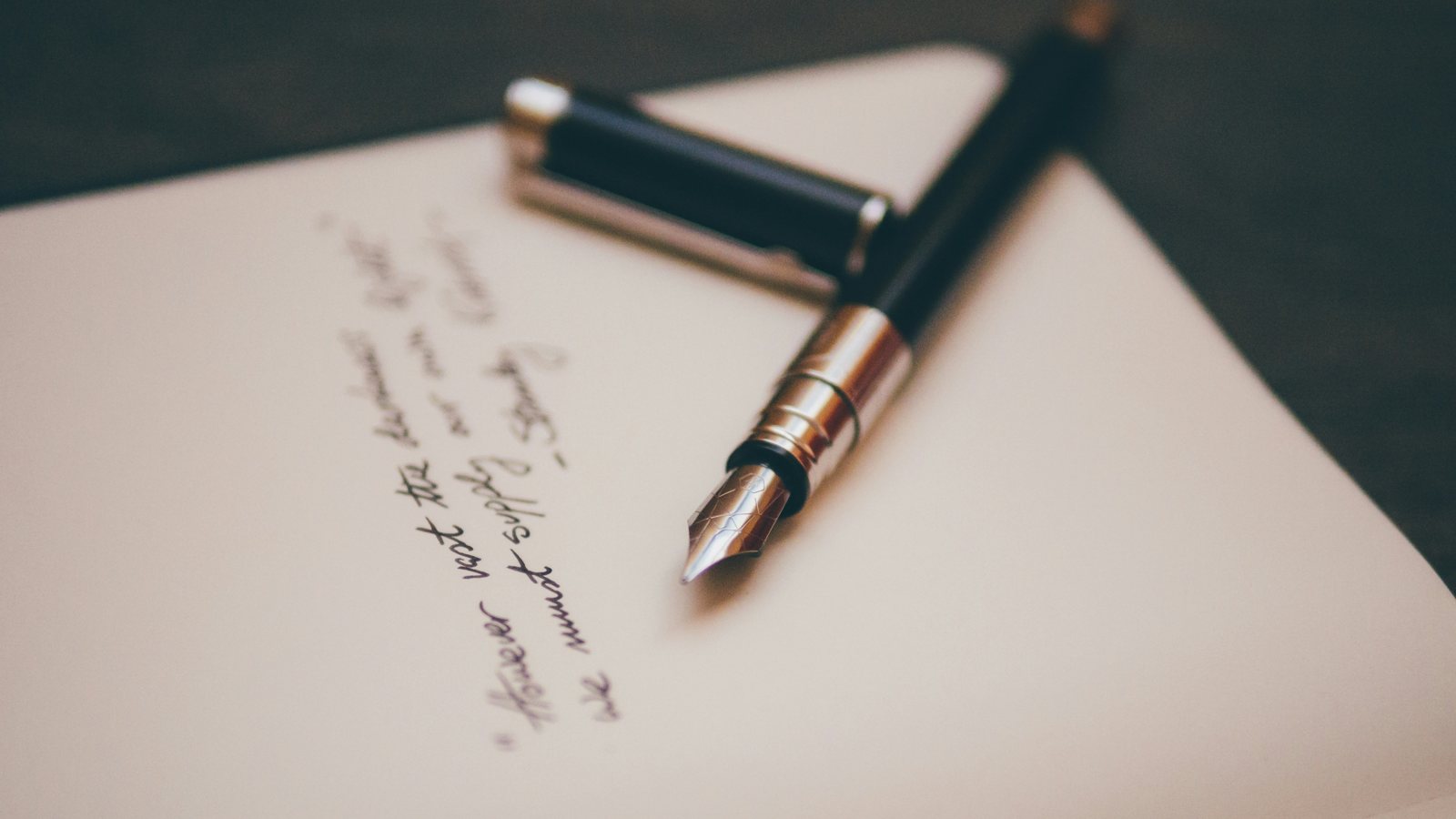 Fountain pen resting on a handwritten document